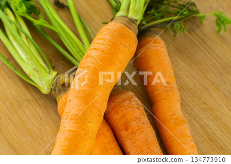 red carrot lies on the table on a wooden background 134773910