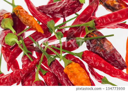 The peppers are all different sizes and some are slightly burnt. 134773930