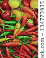 The peppers are of different sizes and colors, creating a vibrant and colorful display. Concept of abundance and variety 134773935