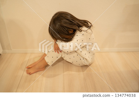 Crying girl sitting on the floor Crying girl sitting on the floor 134774038