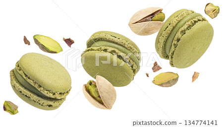 Pistachio macarons flying with nuts isolated on white background, full depth of field Pistachio macarons flying with nuts isolated on white background, full depth of field 134774141