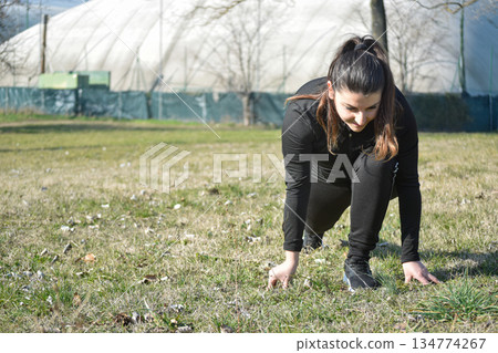 Woman with visual disabilities exercising in the park and stretching Woman with visual disabilities exercising in the park and stretching 134774267