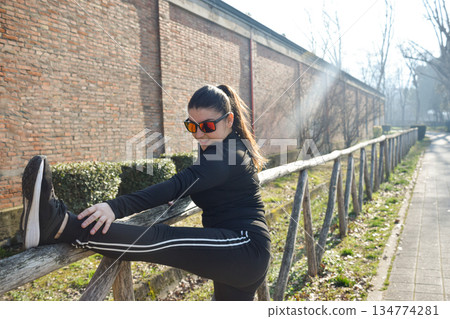 Woman with visual disabilities exercising in the park and stretching Woman with visual disabilities exercising in the park and stretching 134774281