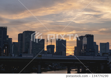 Tokyo landscape with sunset skyline and city buildings silhouettes, bridge and river 134774290