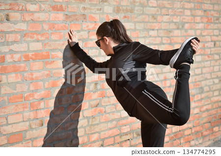 Woman with visual disabilities exercising in the park and stretching Woman with visual disabilities exercising in the park and stretching 134774295