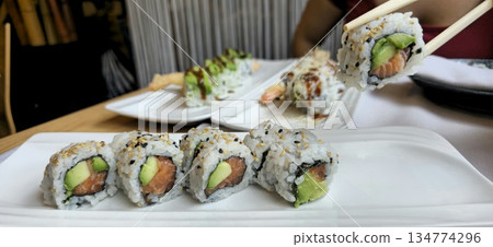 Delicious Sushi Platter with Salmon and Avocado Rolls 134774296