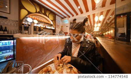 Woman with gentle smile savoring her first bite at dinner Woman with gentle smile savoring her first bite at dinner 134774548