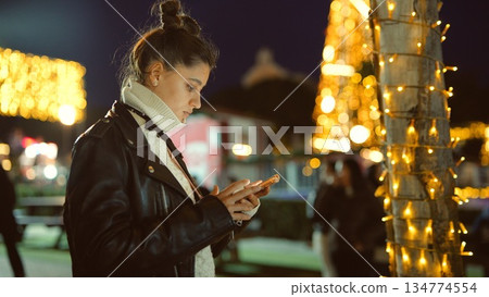 Lady communicating quietly under gentle decorative light 134774554