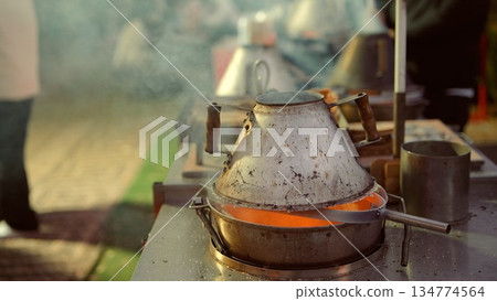 Cozy street market illuminated by warm glow and fragrant culinary creations 134774564