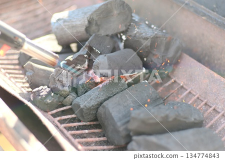 Lighting charcoal for a charcoal grill Lighting charcoal for a charcoal grill 134774843