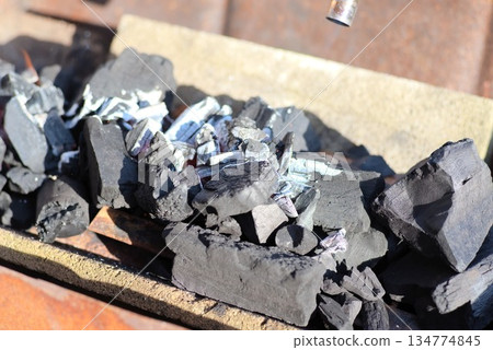 Lighting charcoal for a charcoal grill 134774845