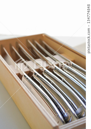 Set of steak knives in a gift wooden box, close-up Set of steak knives in a gift wooden box, close-up 134774848