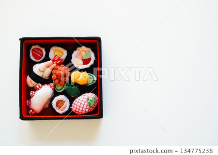 Assorted sushi made from cloth, white background, copy space, overhead shot Assorted sushi made from cloth, white background, copy space, overhead shot 134775238