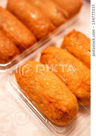 Inari sushi made with fluffy fried tofu and served with pickled ginger Inari sushi made with fluffy fried tofu and served with pickled ginger 134775333