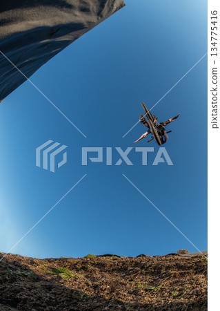 BMX Bike jump over a dirt trail 134775416