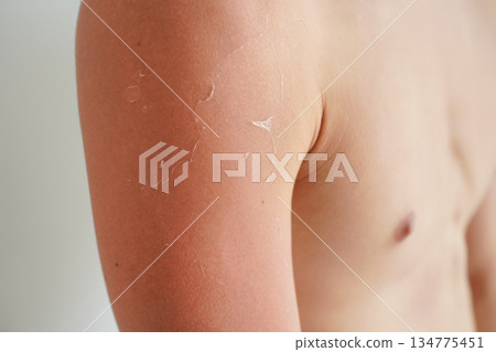 Close-up of a tanned young man's arm on a white background Close-up of a tanned young man's arm on a white background 134775451