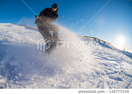 Snowboard freerider in the mountains 134775539