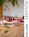 Exercises with pilates ring. Woman doing aerobics workout at pilates studio with panoramic windows. 134775732