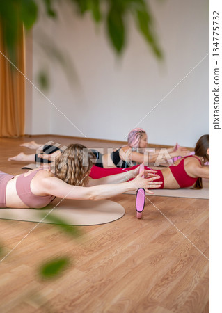 Exercises with pilates ring. Woman doing aerobics workout at pilates studio with panoramic windows. 134775732