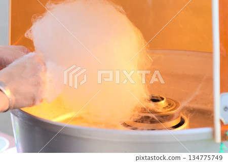 Making cotton candy at a festival Making cotton candy at a festival 134775749