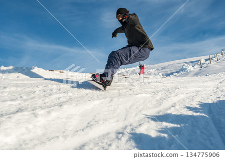 Snowboard freerider in the mountains Snowboard freerider in the mountains 134775906