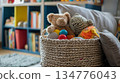 Woven basket overflowing with toys in playroom 134776043
