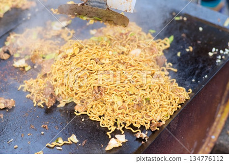 Yakisoba cooked on a hot plate at a food stall Yakisoba cooked on a hot plate at a food stall 134776112