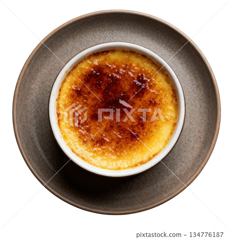 Delicious creme brulee dessert with caramelized top. Sweet gourmet custard food served on matte dish, overhead 134776187