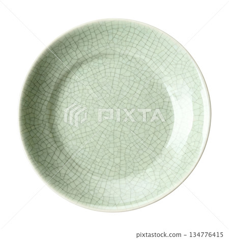 Elegant celadon plate with green crackle glaze. beautiful traditional ceramic piece from top view perspective Elegant celadon plate with green crackle glaze. beautiful traditional ceramic piece from top view perspective 134776415