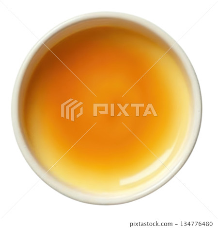 Soothing golden tea in cup, warm drink from top view. relaxing beverage for calm morning moment 134776480