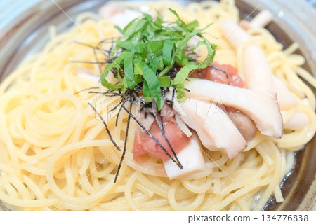 Japanese-style pasta with plum and mushrooms 134776838