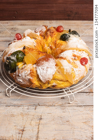 Merry Christmas cake with nuts - Bolo Rei is a traditional Xmas cake with fruits raisins nut and icing on wooden table Merry Christmas cake with nuts - Bolo Rei is a traditional Xmas cake with fruits raisins nut and icing on wooden table 134777094