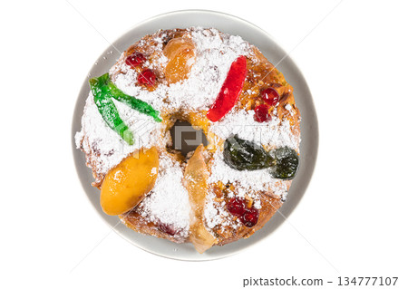 Bolo do Rei or King's Cake, Made for Christmas, Carnavale or Mardi Gras top view on ceramic plate. Isolated on white background 134777107