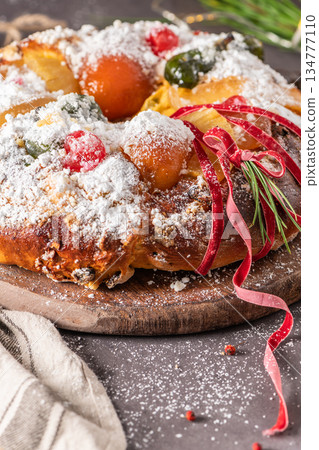 Bolo do Rei or King s Cake, Made for Christmas, Carnavale or Mardi Gras with Christmas season elements in Background. Bolo do Rei or King s Cake, Made for Christmas, Carnavale or Mardi Gras with Christmas season elements in Background. 134777110