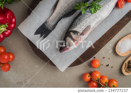 Fresh fish sea bass on wooden table. 134777237