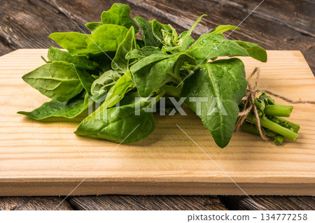 Spinach leaves on a wooden background Spinach leaves on a wooden background 134777258