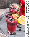 Fresh blueberry summer mojito cocktail. Blueberry lemonade or sangria on kitchen countertop. 134777260