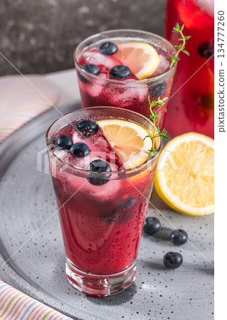 Fresh blueberry summer mojito cocktail. Blueberry lemonade or sangria on kitchen countertop. 134777260