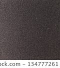Background texture of a shiny metal sheet with a rough stippled textured surface reflecting light. Metal texture 134777261