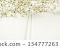 A bouquet of gypsophila flowers lay on the wooden table. Vintage style image. Copy space 134777263
