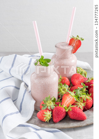 Strawberry milkshake or smoothie in glass jars Strawberry milkshake or smoothie in glass jars 134777265