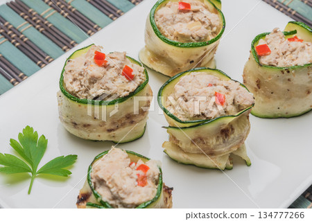 Grilled zucchini rolls with curd cheese and tuna on plate. Grilled zucchini rolls with curd cheese and tuna on plate. 134777266