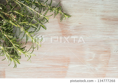 Bunch of fresh of garden rosemary on wooden table, rustic style, fresh organic herbs. Top view with copy space 134777268