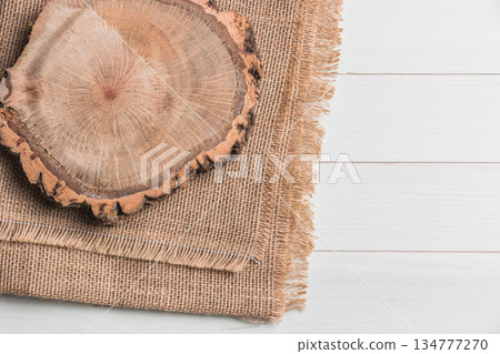 Wood plank board above burlap on wooden table 134777270