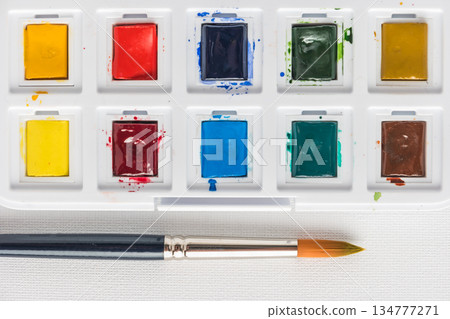 Box of watercolor paints and brushes Box of watercolor paints and brushes 134777271