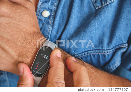 Man checking heart rate on fitness tracker smartwatch Man checking heart rate on fitness tracker smartwatch 134777307