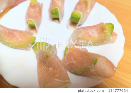 Avocado appetizer wrapped in prosciutto 134777664