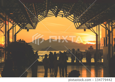 Oct 1 2025 Sunset Silhouettes On A Modern Rooftop Pier As People Oct 1 2025 Sunset Silhouettes On A Modern Rooftop Pier As People 134779442