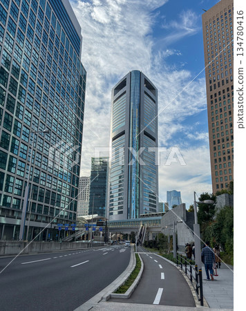 Modern skyscrapers towering against the blue sky and flowing clouds November 2025 Chuo Ward, Japan 134780416