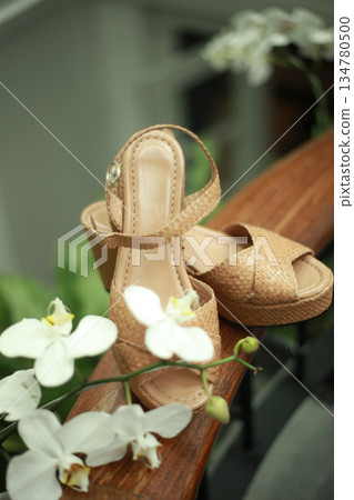 Stylish and highly fashionable woman high heeled shoes with trendy accessories, captured on a colorful background, exuding luxury and elegance perfect for wedding or formal outfit inspiration Stylish and highly fashionable woman high heeled shoes with trendy accessories, captured on a colorful background, exuding luxury and elegance perfect for wedding or formal outfit inspiration 134780500